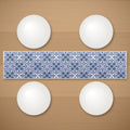 Garden table runner on a wooden table with plates
